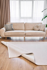 Tapis mécanique moderne Selvin écru, à motif uni et texture tissée