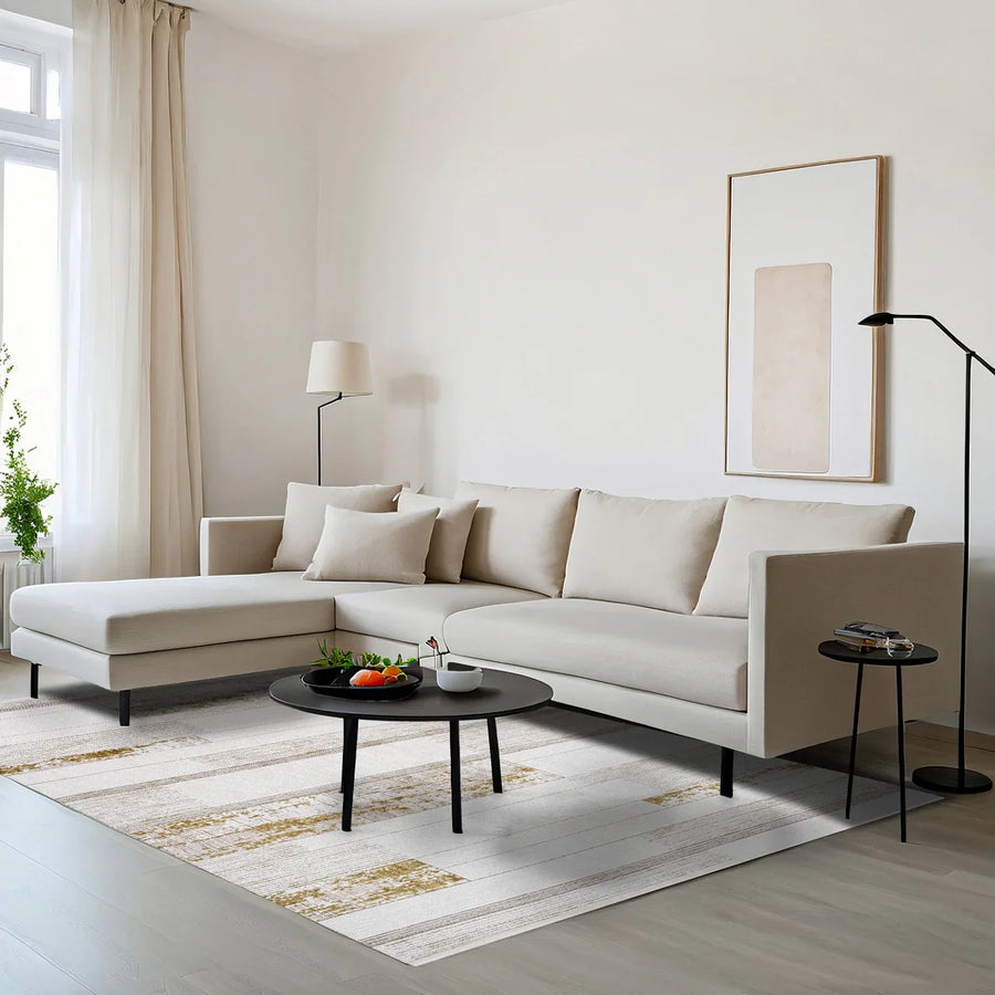 Modern White and Gold Abstract Area Rug – in the living room