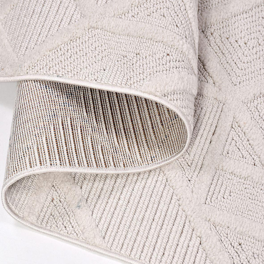 Cream Area Rug with Embossed Geometric Pattern – in the living room