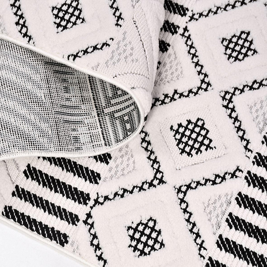 Bohemian Geometric Area Rug in Black and White – in the hallway