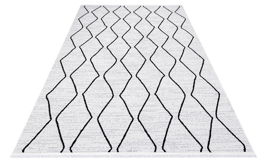 Geometric Area Rug in White, Black and Grey – in the living room