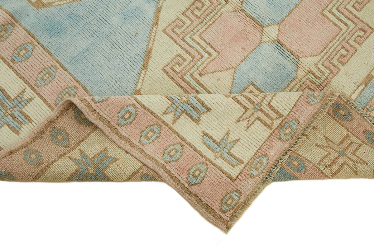 Kavale Madalyon Desenli Mavi ve Toz Pembe El Dokuma Halı 148x228 cm – kenar detayı