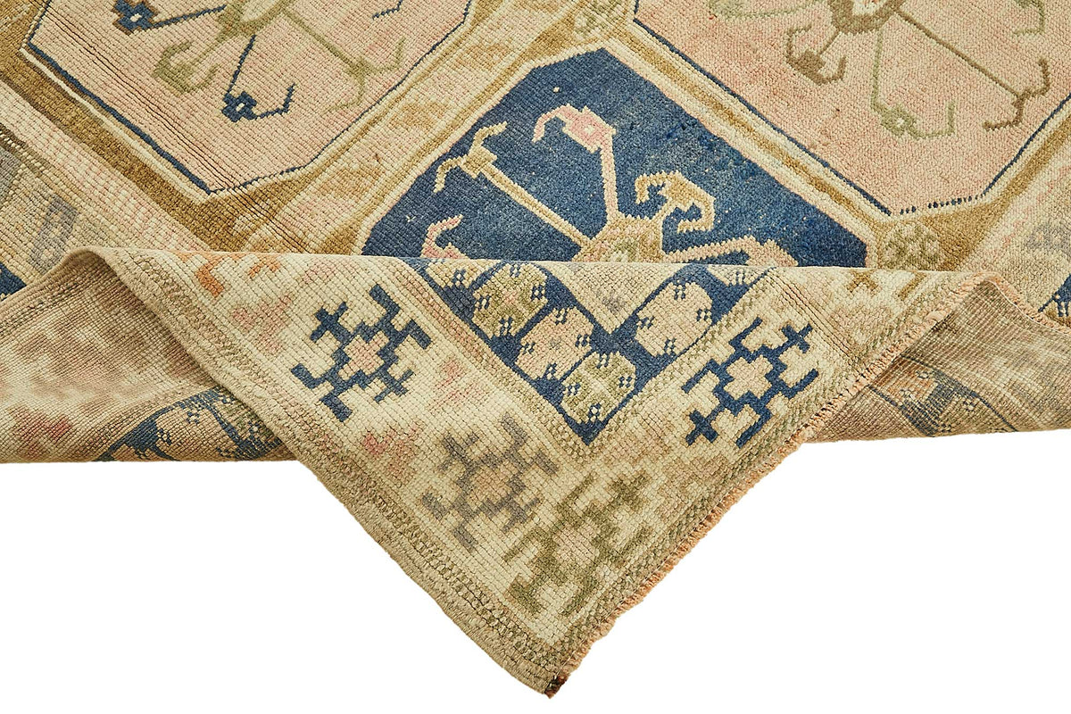 Kavale Bej Lacivert Madalyon Desenli Yün El Dokuma Halı 167x250 cm – kenar detayı