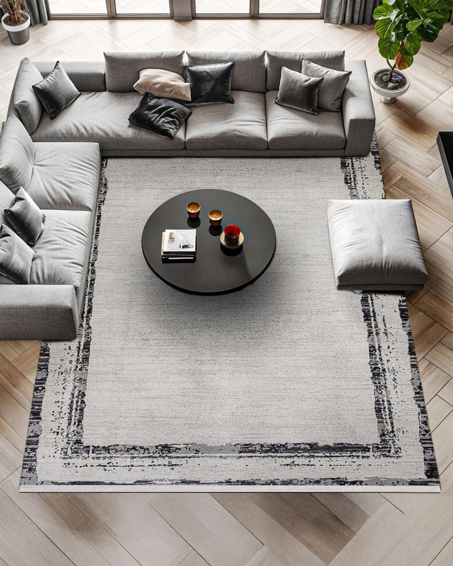 Grey and Black Abstract Modern Area Rug – in the living room