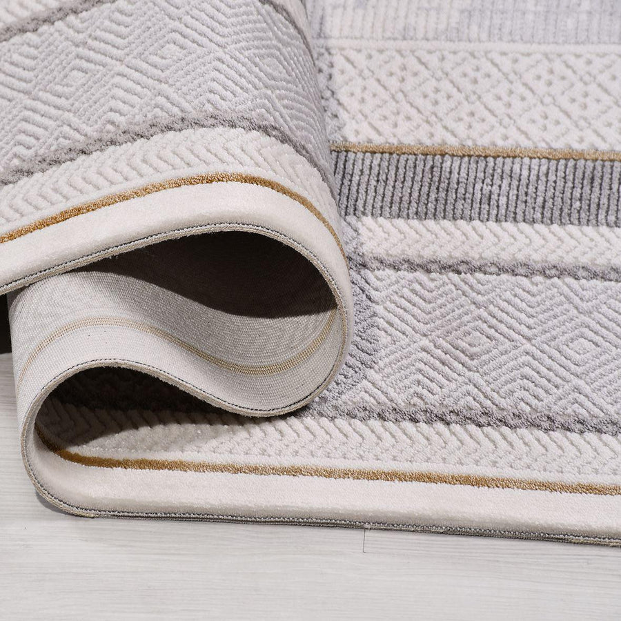 Grauer Teppich im Vintage-Stil mit abstraktem Muster – im Wohnzimmer