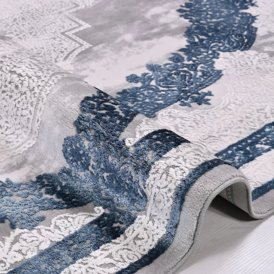 Grey Medallion Area Rug with Navy Border – in the living room