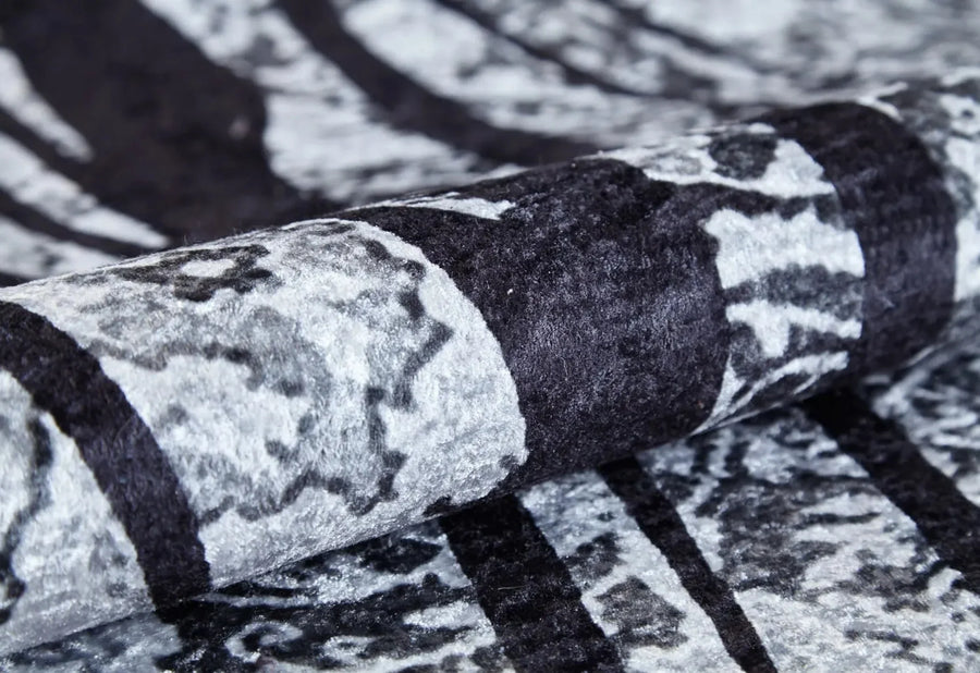 Abstract Charcoal Grey and White Area Rug – in the living room